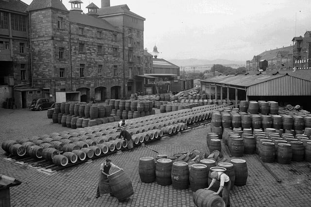 Workmen rolling barrels at Craigmillar's Drybrough Brewery in August 1955. The brewery closed in 1987 and the site was subsequently demolished and replaced by flats.