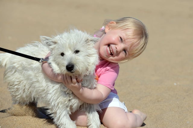 Ella Ogden, aged three and from Jarrow, enjoys the 2015 April sunshine at Sandhaven Beach with dog Belle.
