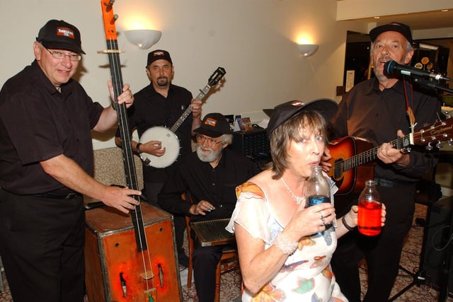 Christine Bellamy playing the milk bottles at her 60th birthday bash at Baldwins Omega, Sheffield  with the Adam Pemberton Yorkshire teabags skiffle band. They are, left to right, Ken Lister on the two-string tea chest bass, Keith Martin on banjo, Dave Apinwall on washboard and Adam Pemberton on guitar
