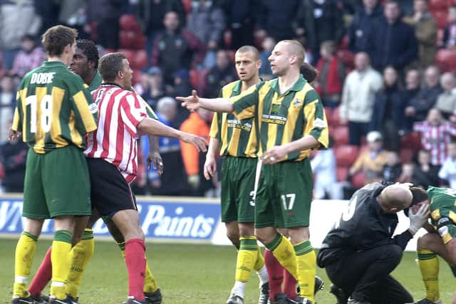 Sheffield Utd Captain Keith Curle (centre left) almost gets involved in another fight whilst West Brom Skipper Derek McInnes (right) is treated after being struck during their Nationwide League Division One match at Sheffield United's Bramall Lane ground, Saturday March 16, 2002. PA Photo: Paul Barker.
