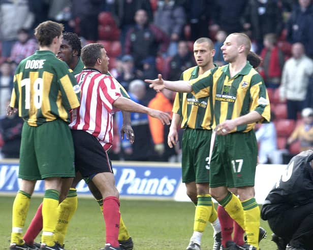Sheffield Utd Captain Keith Curle (centre left) almost gets involved in another fight whilst West Brom Skipper Derek McInnes (right) is treated after being struck during their Nationwide League Division One match at Sheffield United's Bramall Lane ground, Saturday March 16, 2002. PA Photo: Paul Barker.