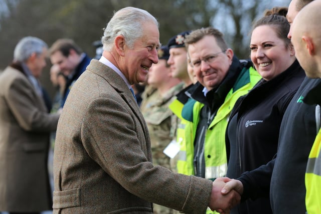 The Prince of Wales meeting emergency services personnel before touring the village of Fishlake last December