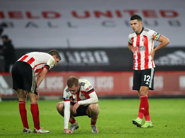Dejected Sheffield United trio Chris Basham, Oli McBurnie and John Egan at the final whistle following the Blades' 2-1 defeat to Leicester City at Bramall Lane yesterday. Photo: Simon Bellis/Sportimage