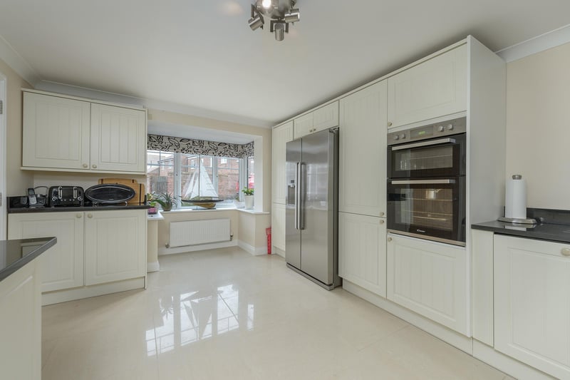 The sizeable kitchen benefits from a range of modern base and wall units, built-in appliances and a bay window at the front of the property.