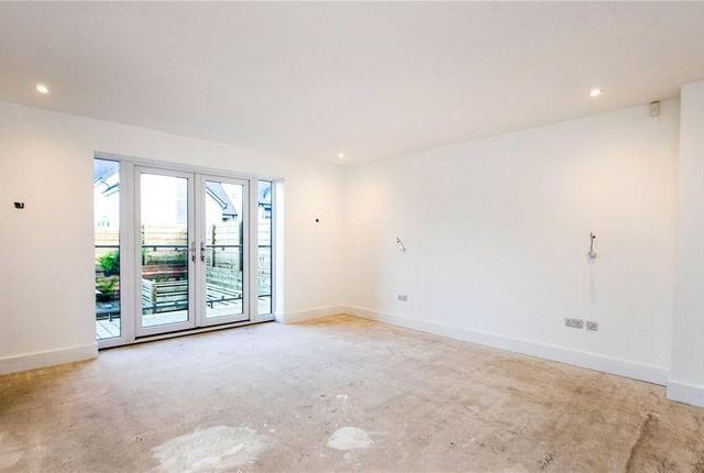 The master suite offers a dressing area, large four piece en suite and French doors open onto a glazed balcony overlooking the rear garden.