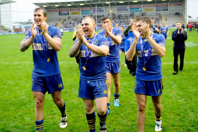 Dons' players celebrate victory over Barrow in the 2012 Championship One play-off final.