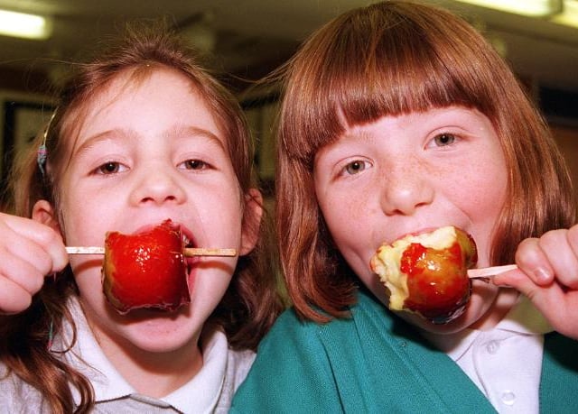 Copley Junior school pupils Jessica Boulton and Rachel Nicol, both seven, biting into toffee apples in 1998.