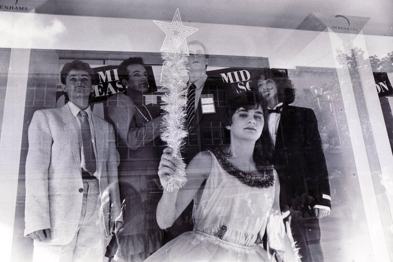 Rag students puzzle the passing shoppers as they pose in Debenhams window on October 22, 1987