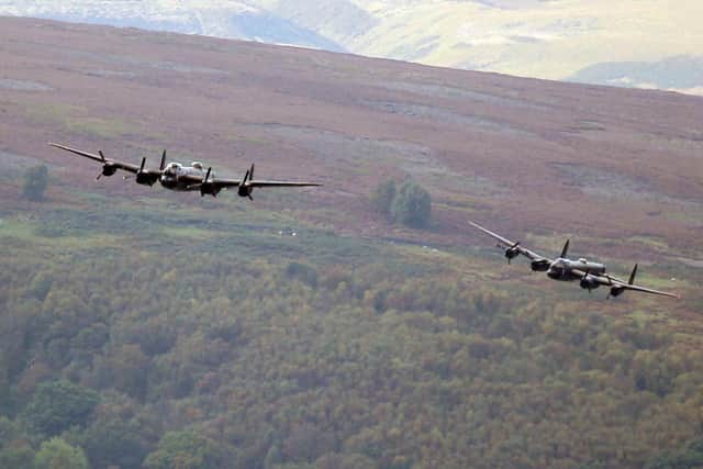 Crowds gathered to watch two Lancaster bombers fly over Derwent Dam in Derbyshire. The RAF BBMF's Lancaster was joined by the Canadian Warplane Heritage Museum's V-RA Lancaster.