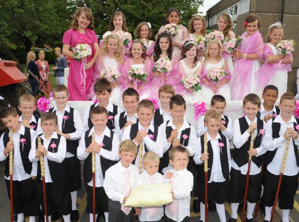 Year 6 boys and girls with reception boys - dressed up to take part in the Maypole celebrations.