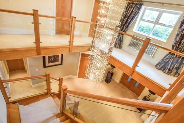 As you walk in the front entrance, you are greeted with an impressive staircase made of glass, steel and oak.