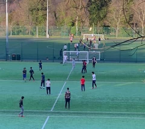 Trespassers flouting lockdown rules by gathering to play football at the University of Sheffield's Goodwin Sports Centre (pic: Glyn Watson)
