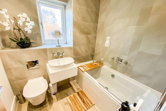 The family bathroom features a full-size tub with a shower overhead.