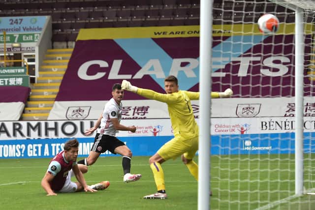 John Egan strikes to score for Sheffield United gainst Burnley at Turf Moor (Photo by PETER POWELL/POOL/AFP via Getty Images)