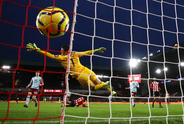 John Fleck scores Sheffield United's first goal past Tom Heaton of Aston Villa during the Premier League match between Sheffield United and Aston Villa at Bramall Lane on December 14, 2019 in Sheffield, United Kingdom. (Photo by Clive Mason/Getty Images)