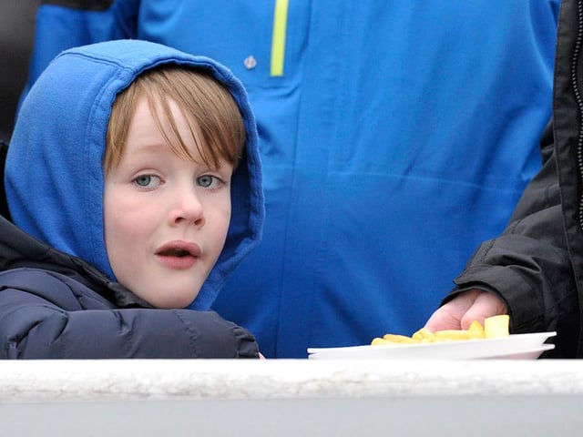 A young fan watches the action unfold at Mariners Park.