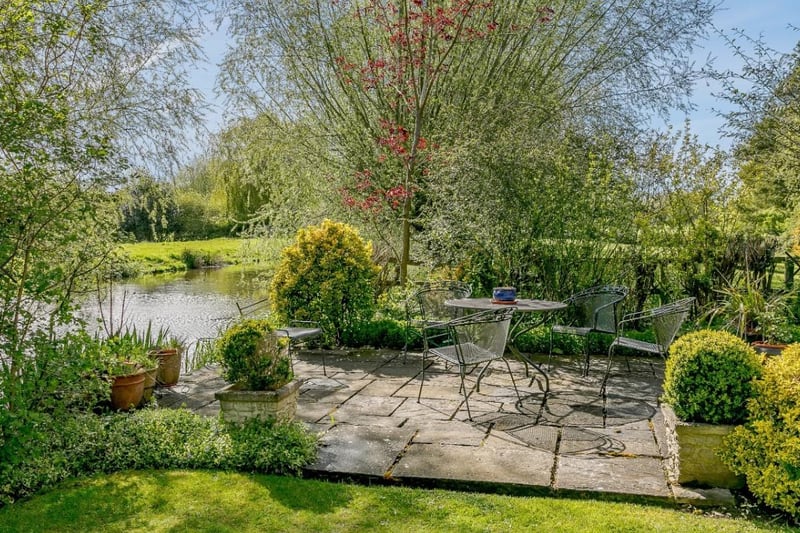 This patio area overlooks the mill pond and is set in an appealing small lawned area to the side of the coach house
