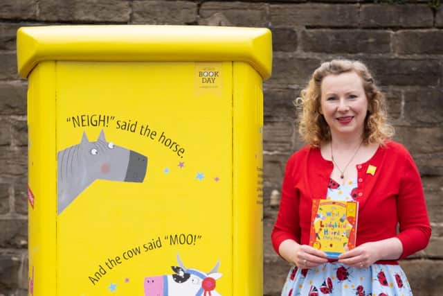 Children's illustrator Lydia Monks beside the post box on Clarkehouse Road, in Sheffield, which has been specially decorated to mark World Book Day (pic: Tom Maddick/Royal Mail)