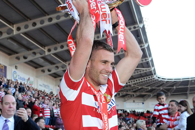 Tommy Spurr with the League One champions' trophy