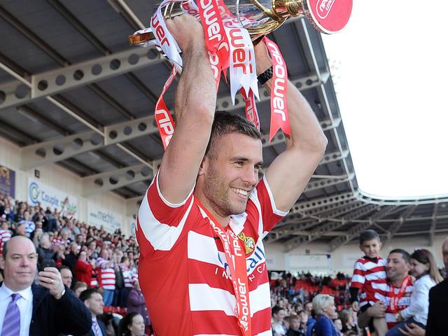 Tommy Spurr with the League One champions' trophy