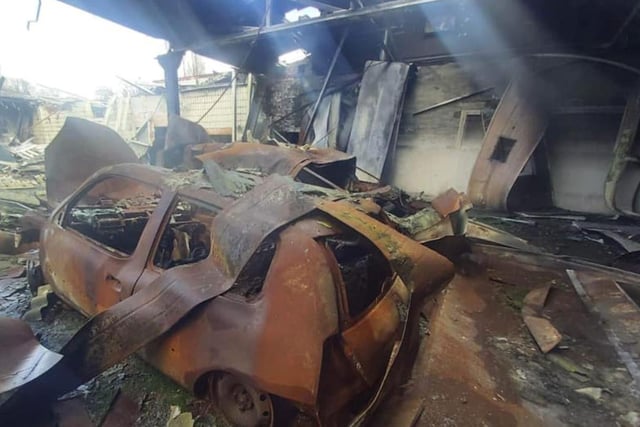 The sunshine can be seen pouring through holes in the roof onto burned out cars at the old Co-op building in Handsworth Hill, Sheffield, in this photo