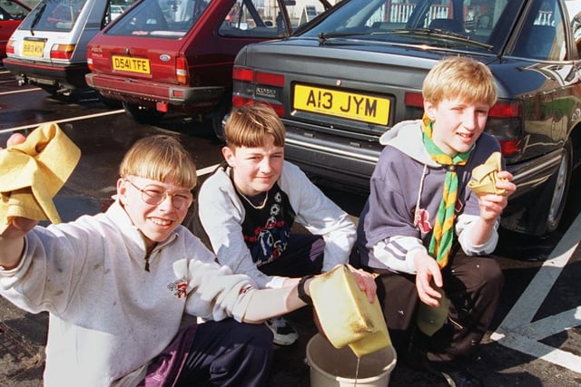 Chris Hurst, 13, Russell Lonsdale 12, Daniel Sharp, 14, with some of the cars they cleaned in 1997
