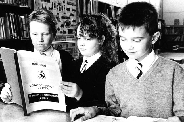First year pupils William Marshall, Susan Harker and Paul Gooding, study the new information  booklet produced by senior pupils to help younger pupils at Brierton School in 1990.