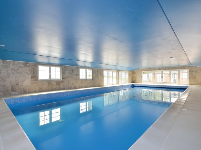 This huge five-bedroom Portsdown Hill home in Portsmouth is up for raffle. Pictured is the property's indoor heated pool. The pool house measures in at 17.58m x 8.86m.