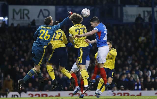 Arsenal's Bailey Wright battles with Portsmouth's Gareth Evans