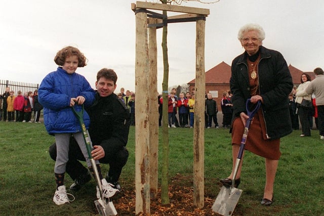 Stainforth School pupil Carrie Errington, Fire fighter Matthew Briggs and the Mayor of Doncaster Margaret Robinson plant one of the new trees at Stainfroth Primary School as part of a combined promotion of the Millenium tree Project in 2000
