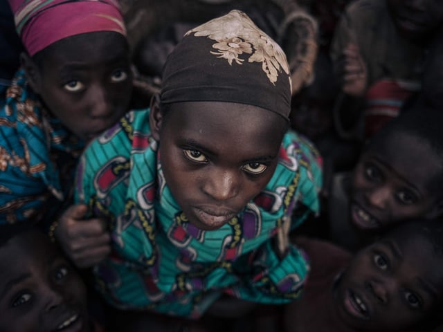 Displaced girls and boys from the Bafuliru community pose for a photograph in the internally displaced persons (IDP) camp of Bijombo, South Kivu Province, eastern Democratic Republic of Congo.