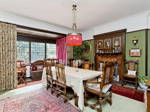 The formal dining room has a unique fire surround and period dado rail and cornice.