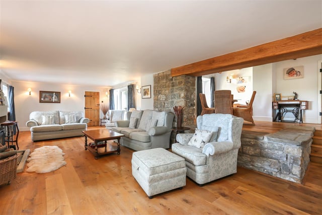 This 'fantastic' family lounge has an elevated dining area and log burner.