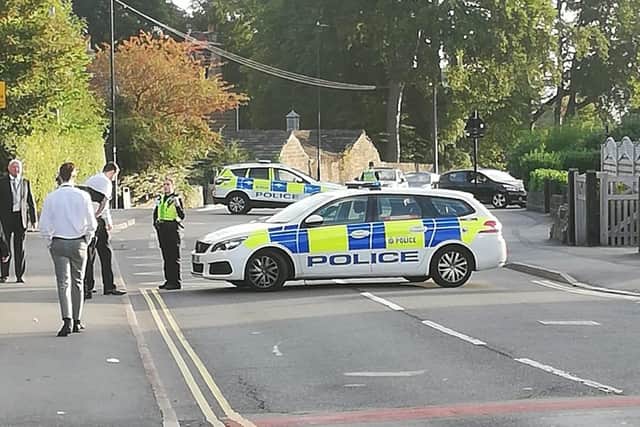 Wood Lane was shut by police after a motorcyclist was reportedly knocked off his bike before it was stolen from him