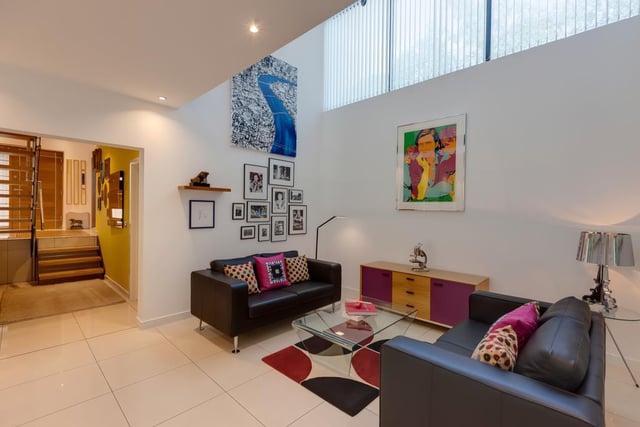 The family room has double height ceiling, recessed lighting and porcelain tiled flooring with underfloor heating.