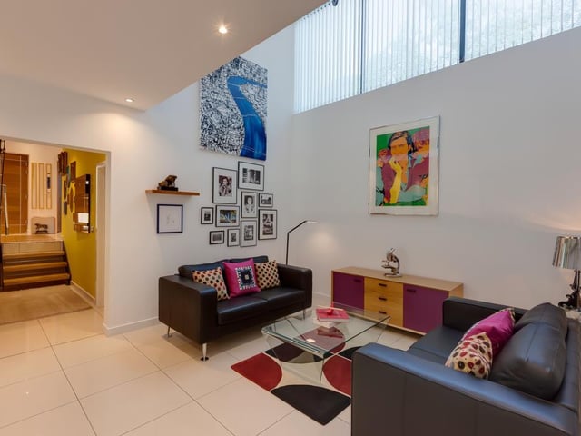 The family room has double height ceiling, recessed lighting and porcelain tiled flooring with underfloor heating.