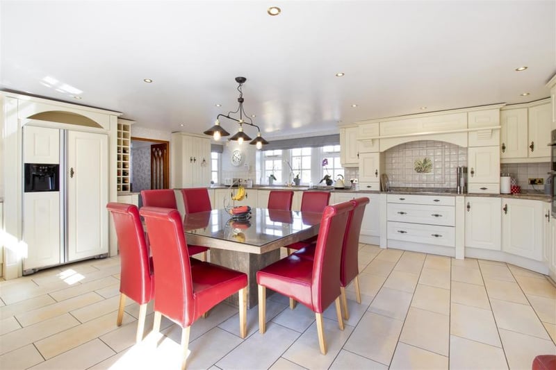 The property boasts a 'stylish kitchen with integrated Neff appliances and solid marble worktops'.