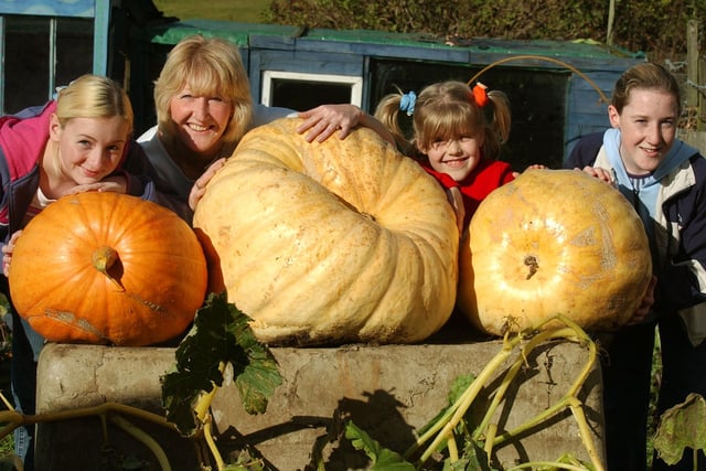 Judith Gray with her daughters and the giant pumpkins they grew on their allotment in 2003.