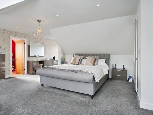 The room has a large window which has views of the garden.