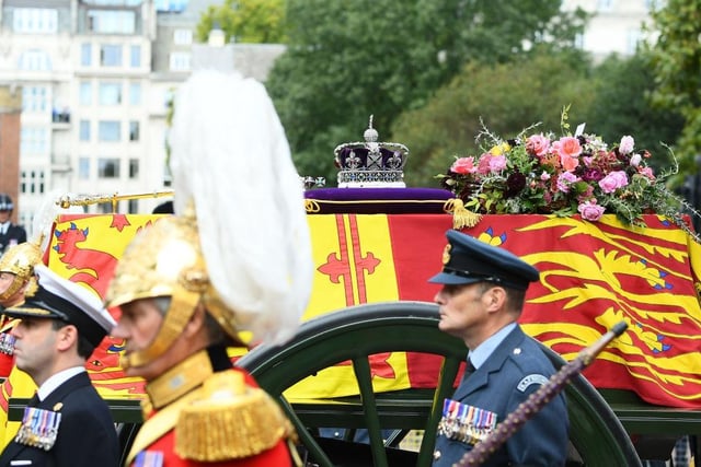 The coffin of Queen Elizabeth II with the Imperial State Crown resting on top is carried by the Bearer Party as it departs Westminster Abbey. Photo by Joe Maher/Getty Images