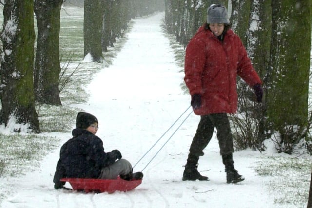 Fun in the snow at Ecclesfield Park in 2001, and no easier way that getting around for a youngster than being pulled along in a sledge. Photo by Dennis Lound.