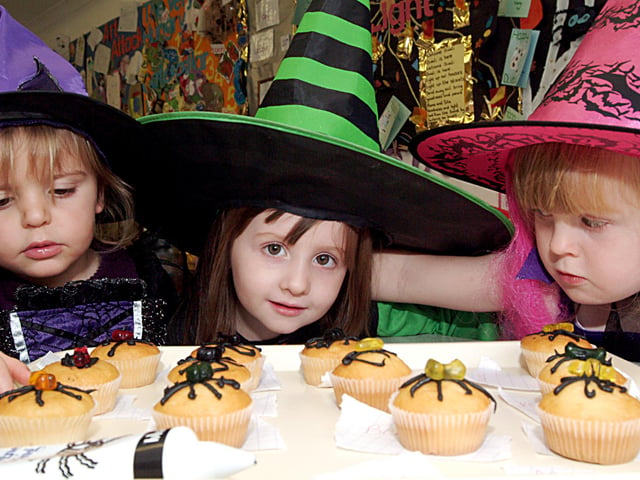 Holly Farbrother 2, Shauna Bailey 3, and Kira Morning 4 making spider cakes at  at the Hucknall Day  Nursery Halloween Fancy dress in 2006