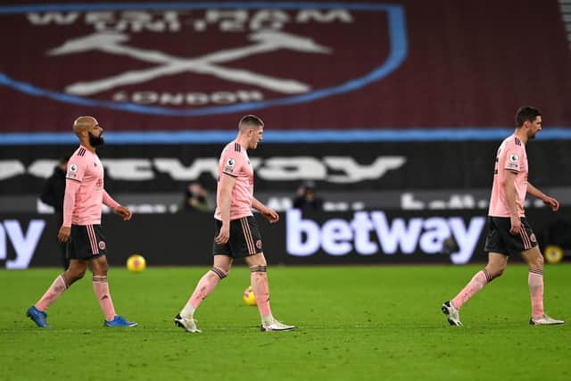 Sheffield United players rect after the final whistle at the London Stadium: Glyn Kirk/PA Wire.