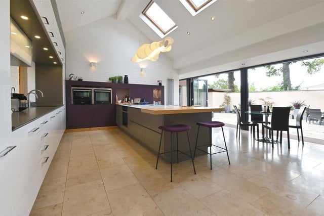 The kitchen is enormous and has those large bi-folding doors off out into the homes amazing grounds.