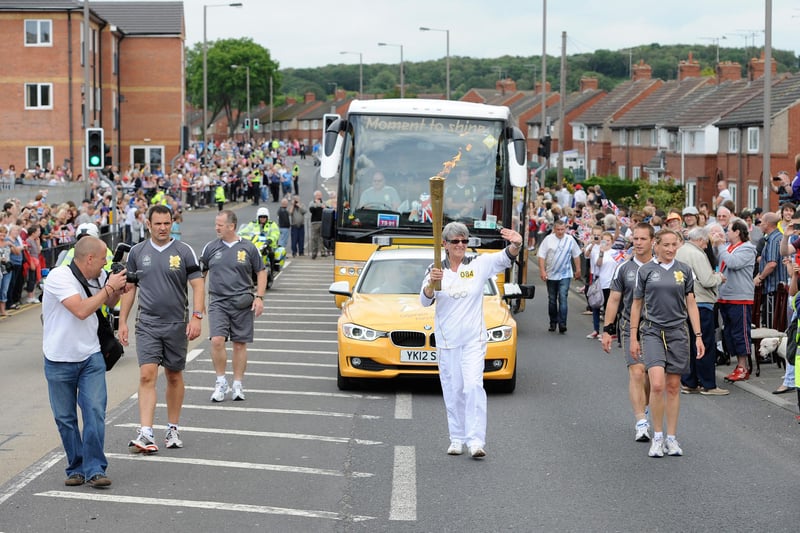 Dorothy Hyman carries the Olympic Flame on the Torch Relay leg between Lundwood and Barnsley