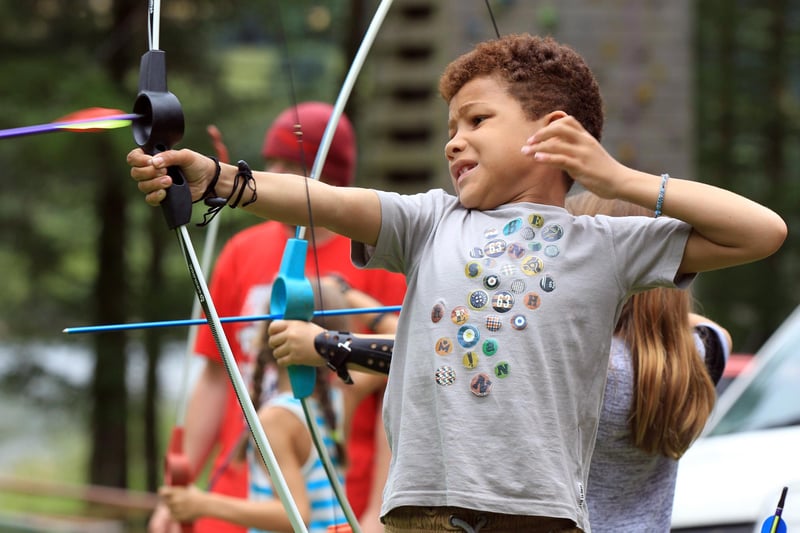 Outdoor have-a-go taster sessions for the summer holidays at Underbank Reservoir Activity Centre near Sheffield - Joel Mckenzie, seven, having a go at archery