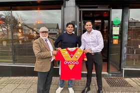 Sheffield Eagles shirt held by the owners of Indus restaurant