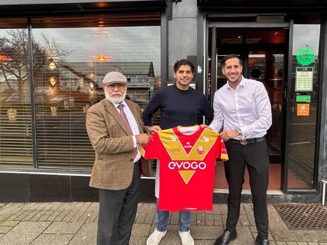 Sheffield Eagles shirt held by the owners of Indus restaurant