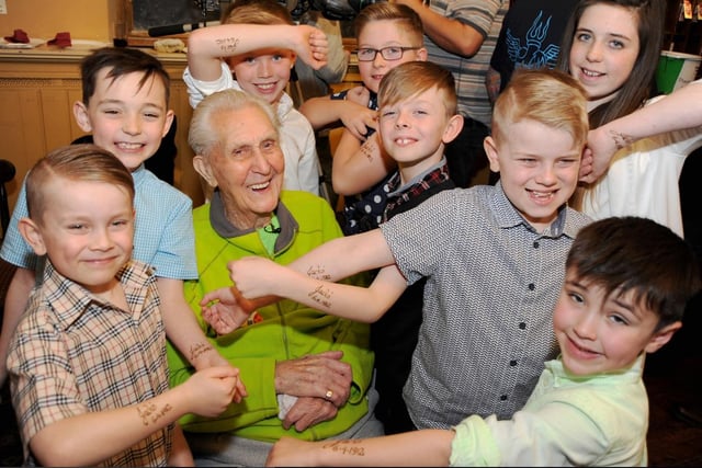 Aged 104, Jack became the oldest person to get a tattoo. Here he is pictured with his great-grandchildren at the time.