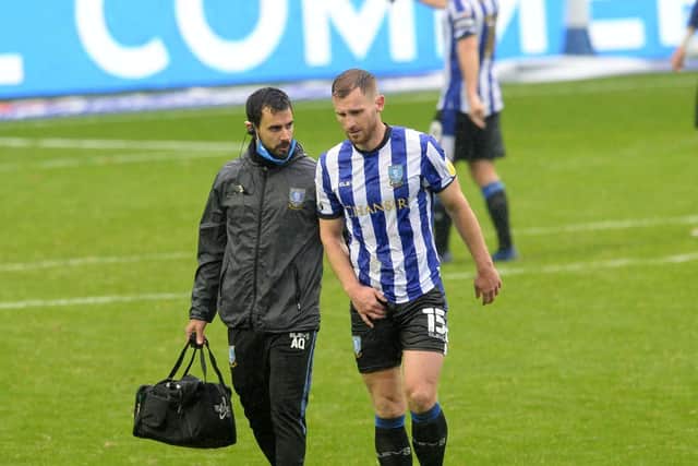 Sheffield Wednesday defender Tom Lees leaves the field in injury time with a groin injury. Photo: Steve Ellis.